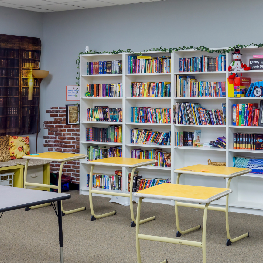 Bookshelves and desks in STARS Academy classroom
