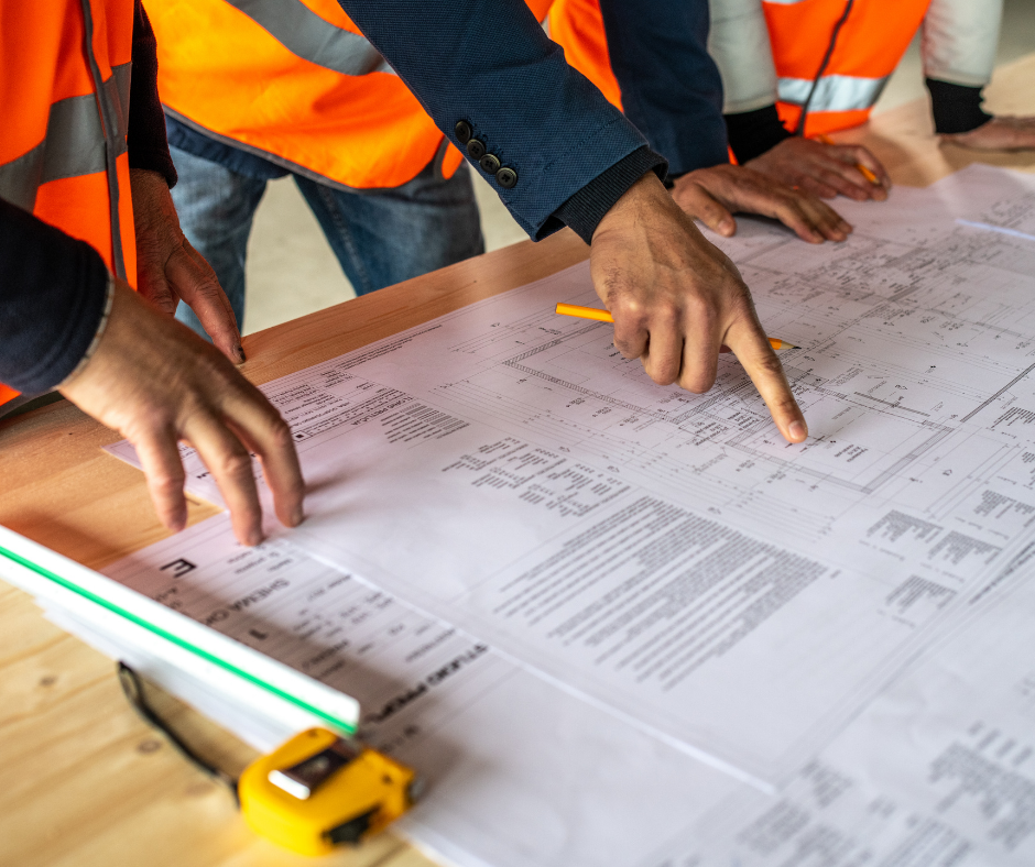 hands pointing at a construction plan