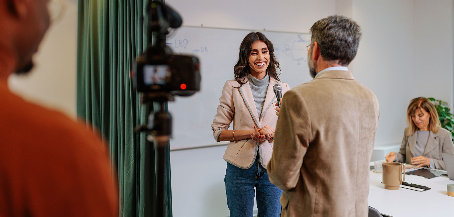 A woman on camera talking to a man