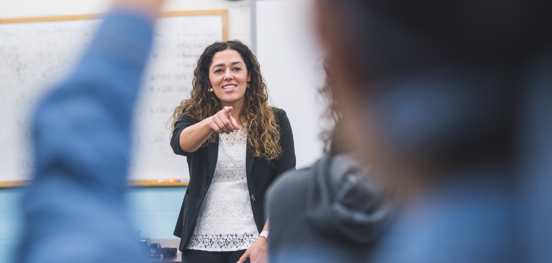 Teacher calling on a student with their hand up