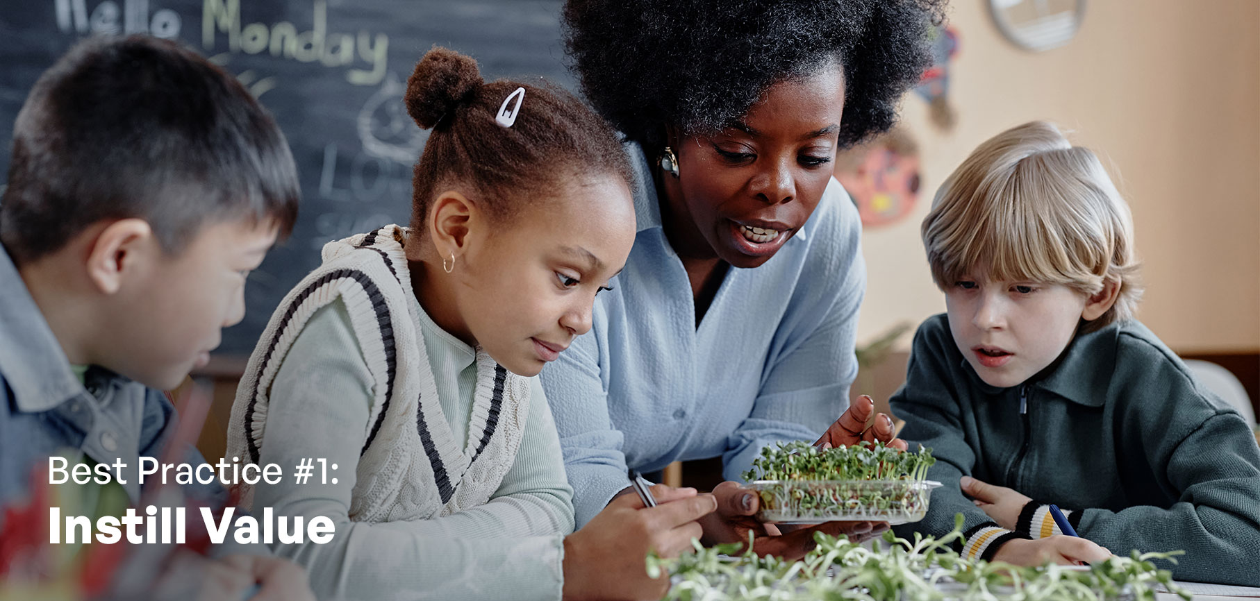 A teacher showing three students plants that are sprouting