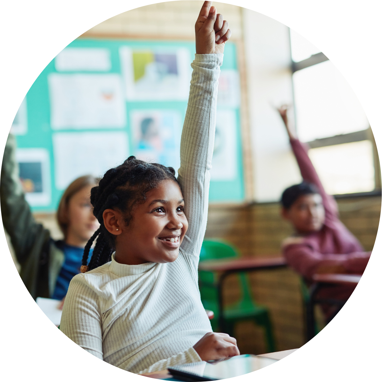 Shot of young children raising their hands in a classroom