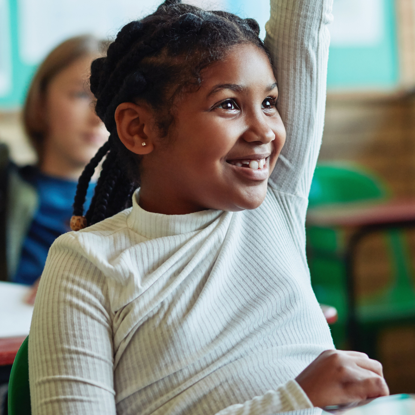 Girl raising her hand in a classroom