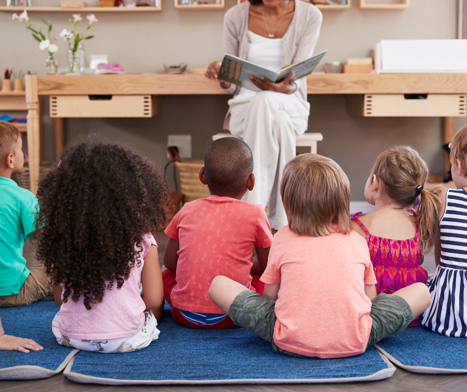 Students listening to a story while sitting on the carpet.