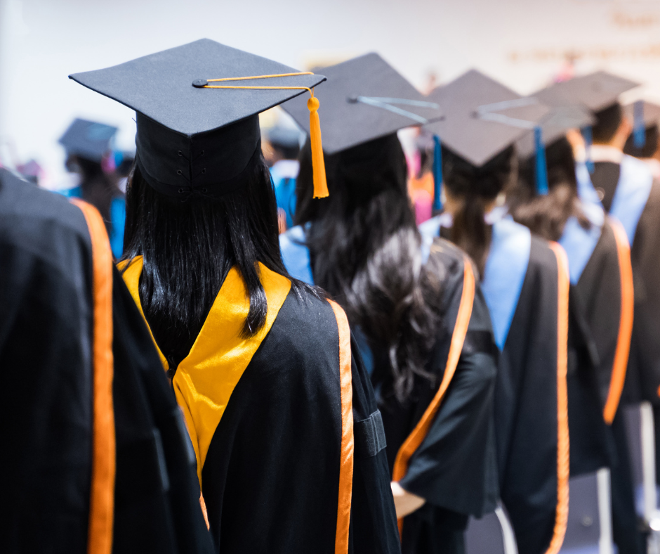 graduates stand in a line where caps and gowns.