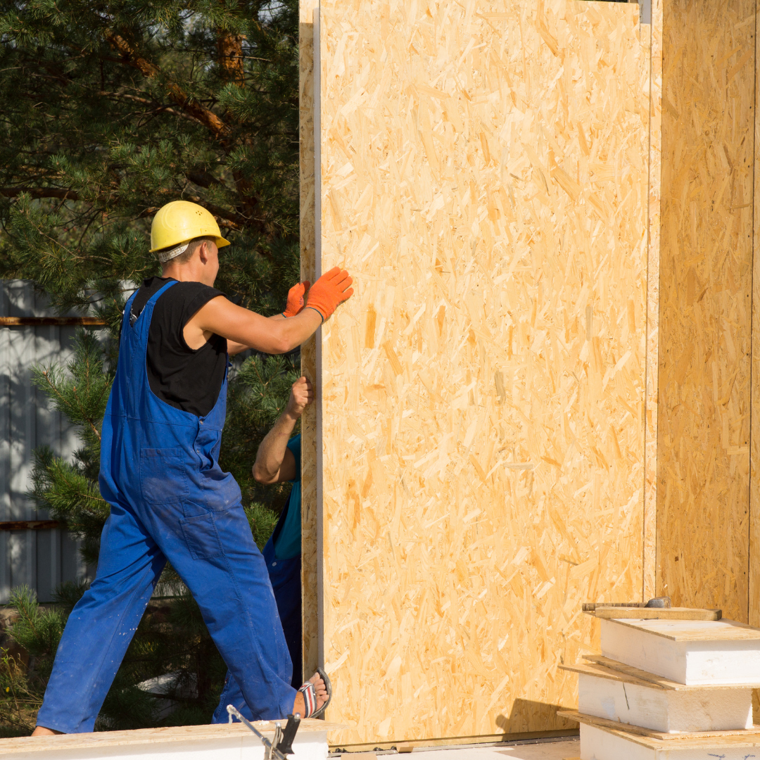 a worker constructing a prefab wall